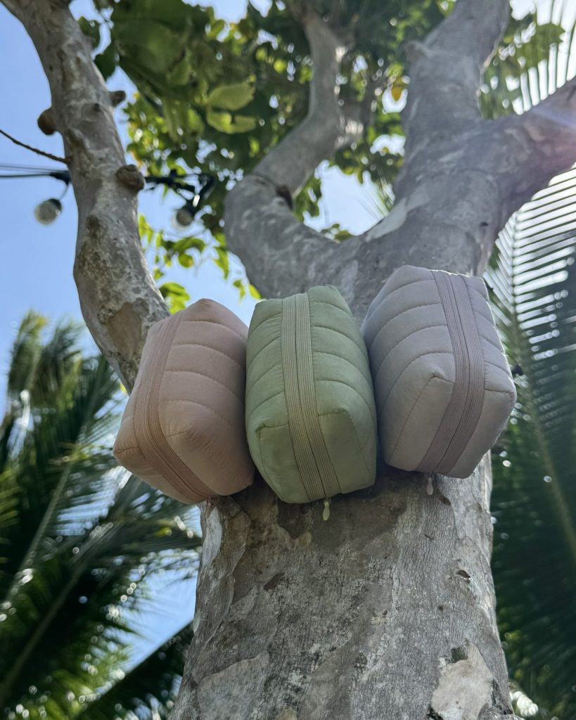Three allour pouches resting on a tree trunk